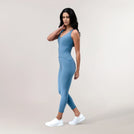 A model wearing a core blue sculpting unitard - عارضة أزياء ترتدي بدلة محبوكة باللون الأزرق