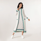 A model wearing seasonal ivory cashmere cardigan over a dress with side stripes - عارضة أزياء ترتدي كارديجان من الكشمير باللون العاجي فوق فستان بخطوط جانبية