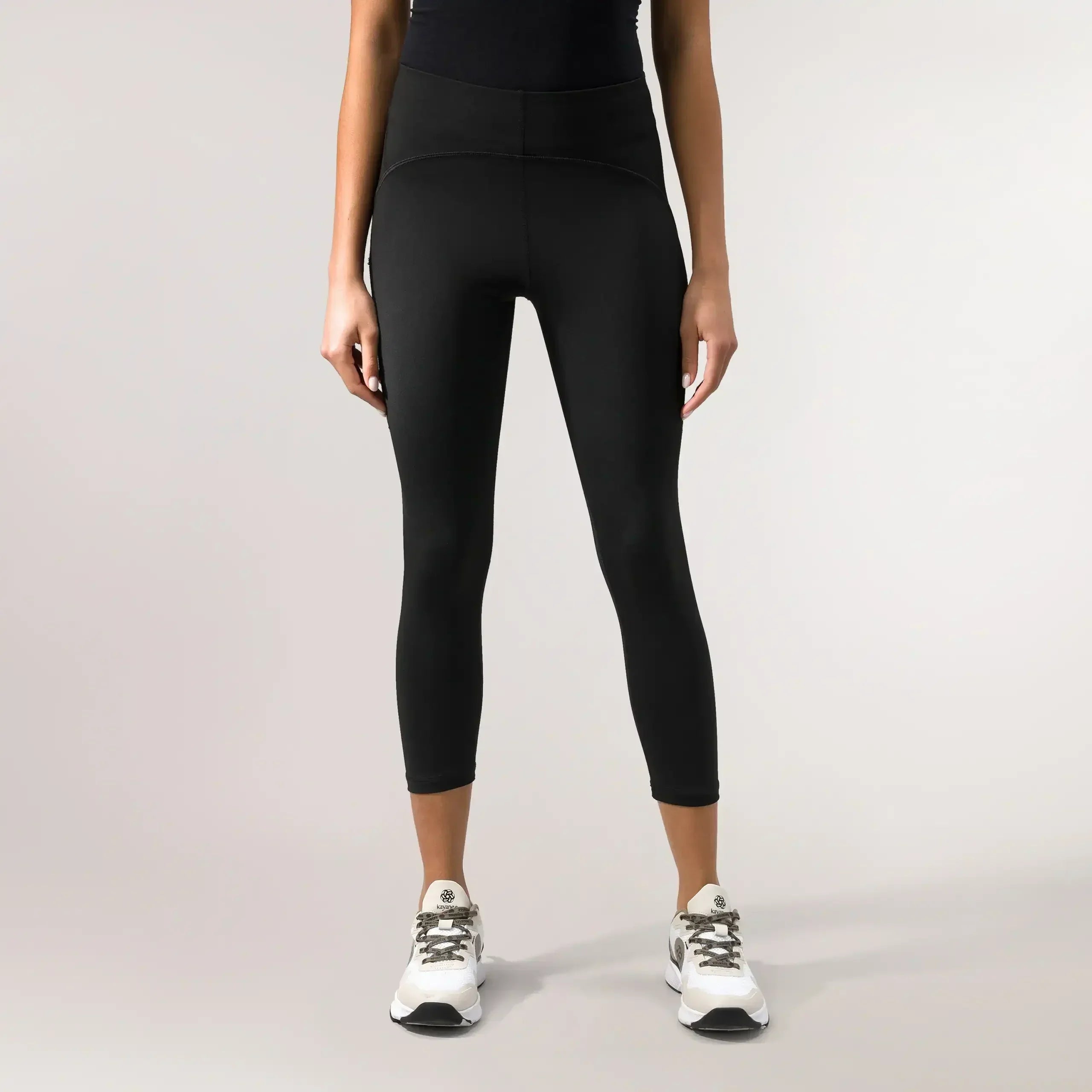 A model wearing Freestyle black cropped leggings with a high-rise fit - عارضة أزياء ترتدي ليقنز قصير بخصر عالٍ من تصميم "فري ستايل" باللون الأسود