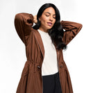A model wearing a seasonal brown hooded parka over white t-shirt - عارضة أزياء ترتدي سترة باركا بنية اللون بغطاء رأس فوق تيشيرت أبيض