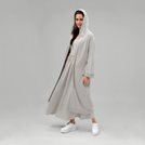 A model wearing core stone hooded good to go abaya - عارضة أزياء ترتدي عباءة بغطاء رأس باللون الحجري