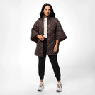 A model wearing front zip puffer cape in a seasonal chocolate shade - عارضة أزياء ترتدي جاكيت بافر بني بسحاب أمامي