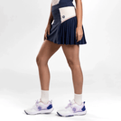 A model wearing a seasonal navy Roland Garros skirt with Kayanee's logo - عارضة أزياء ترتدي تنورة رولان جاروس باللون الأزرق الداكن مع شعار كاياني
