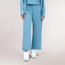 A model wearing core blue "Flow" lounge pants - عارضة أزياء ترتدي بنطال لوْنج "فلو" باللون الأزرق