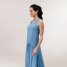 A model wearing core blue "Flow" racerback top over a matching skirt - عارضة أزياء ترتدي توب بقصة ظهر رياضية زرقاء اللون فوق تنورة متناسقة