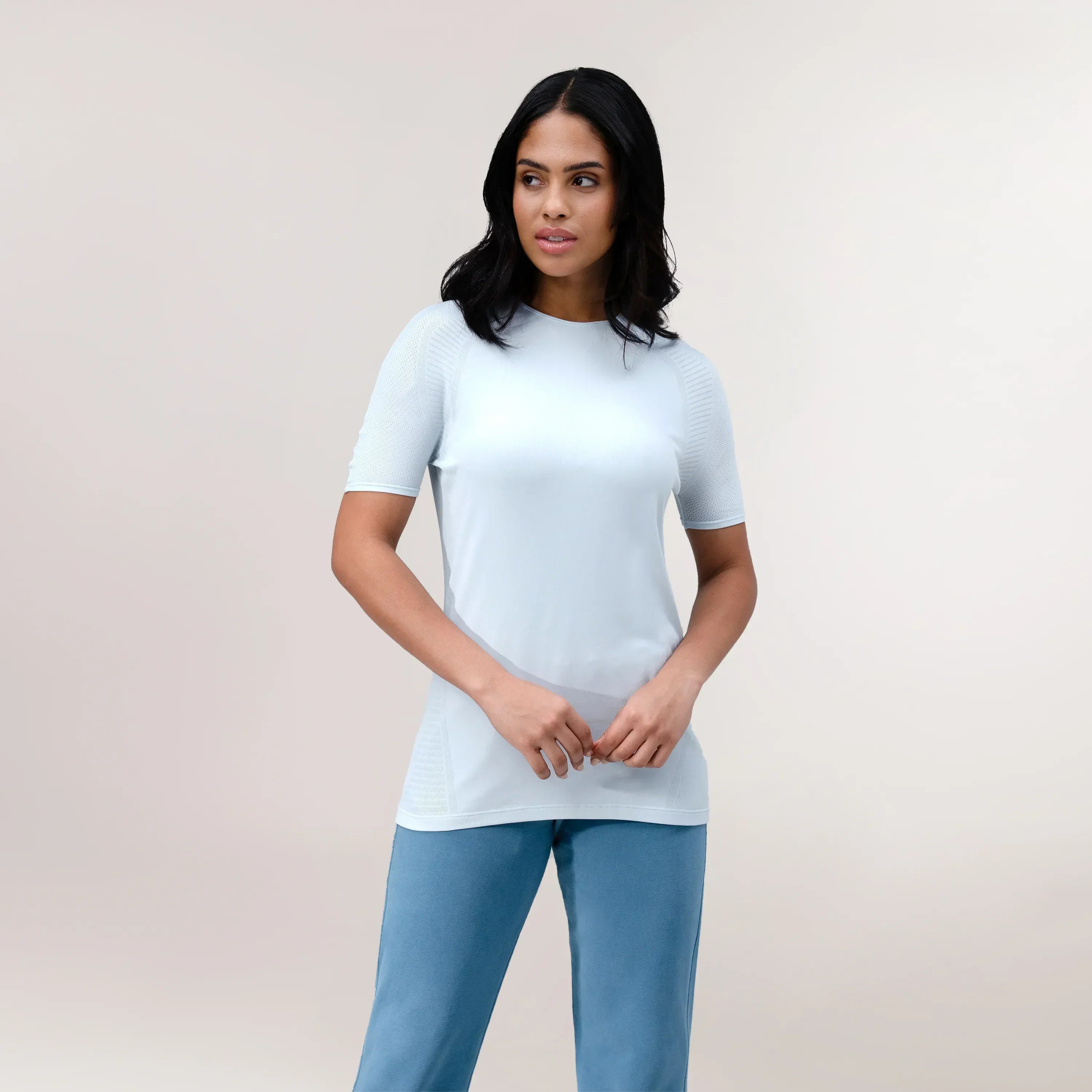 A model wearing a "Limber Up" t-shirt in a core light blue - عارضة أزياء ترتدي تيشيرت "ليمبر آب" رياضي أزرق فاتح اللون