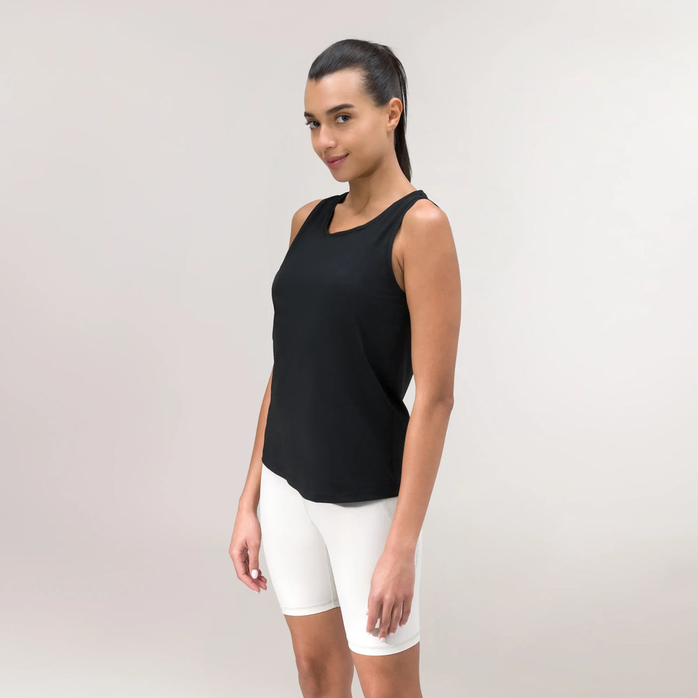 A model wearing a core black "Limber Up" tank over white shorts - عارضة أزياء ترتدي توب أسود فضفاض بتصميم "ليمبر آب" فوق شورت أبيض