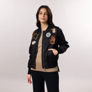 A model in seasonal black bomber jackets with trendy badges - عارضة أزياء ترتدي سترة سوداء ذات شارات عصرية