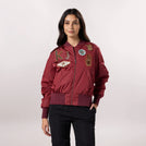 A model in seasonal dark red bomber jacket with trendy badges - عارضة أزياء ترتدي سترة حمراء داكنة مع شارات عصرية