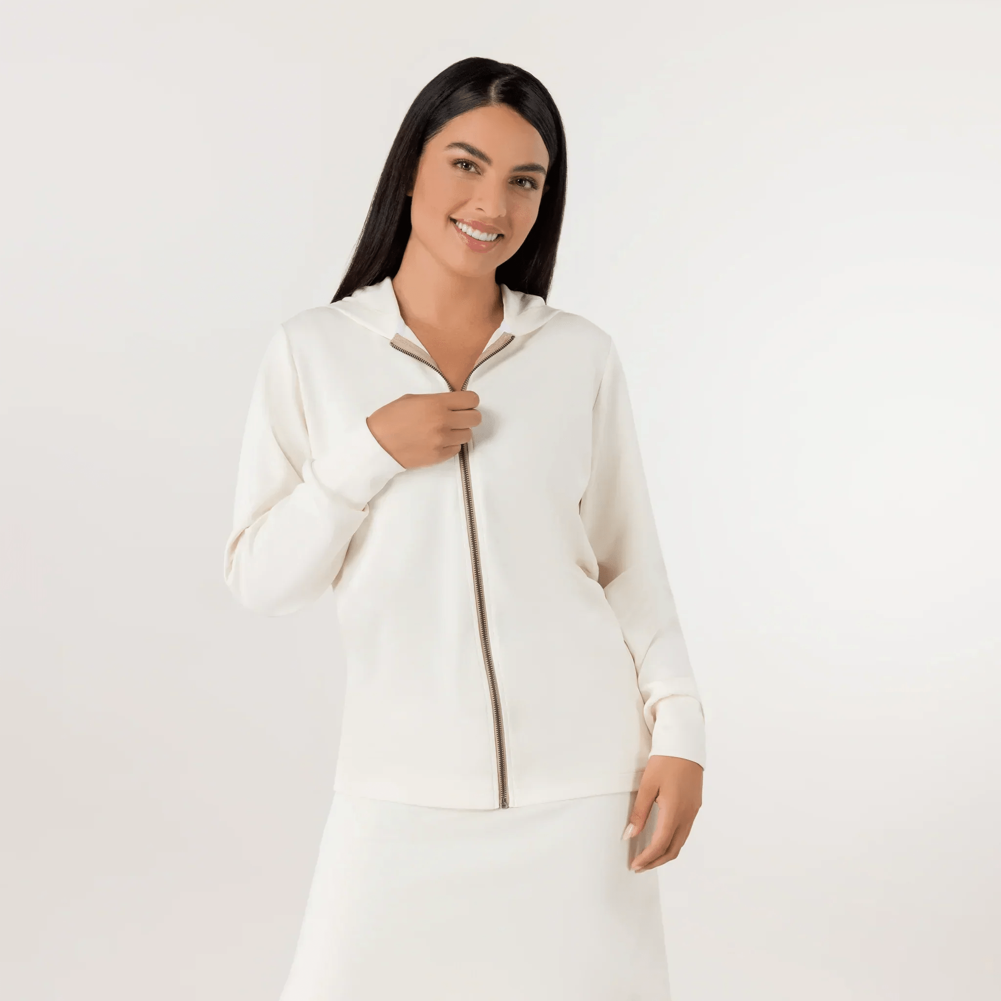 A model in a seasonal beige zipped sweatshirt paired with a skirt - عارضة أزياء ترتدي سترة رياضية ناعمة باللون البيج مع تنورة