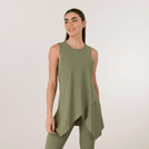 A model wearing a core musk green Twirl Studio top - عارضة أزياء ترتدي بلوزة "تويرل استوديو" دائرية باللون الأخضر